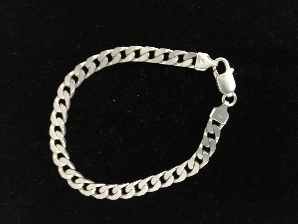 A solid silver curb link bracelet.