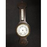 A lovely vintage solid oak barometer and thermometer marked Harrods Ltd London.