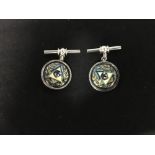 A pair of silver and enamel cufflinks decorated with Masonic symbolism.
