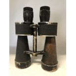 A pair of Kriegsmarine binoculars from WW2 with swastika and eagle stamped ti the body.