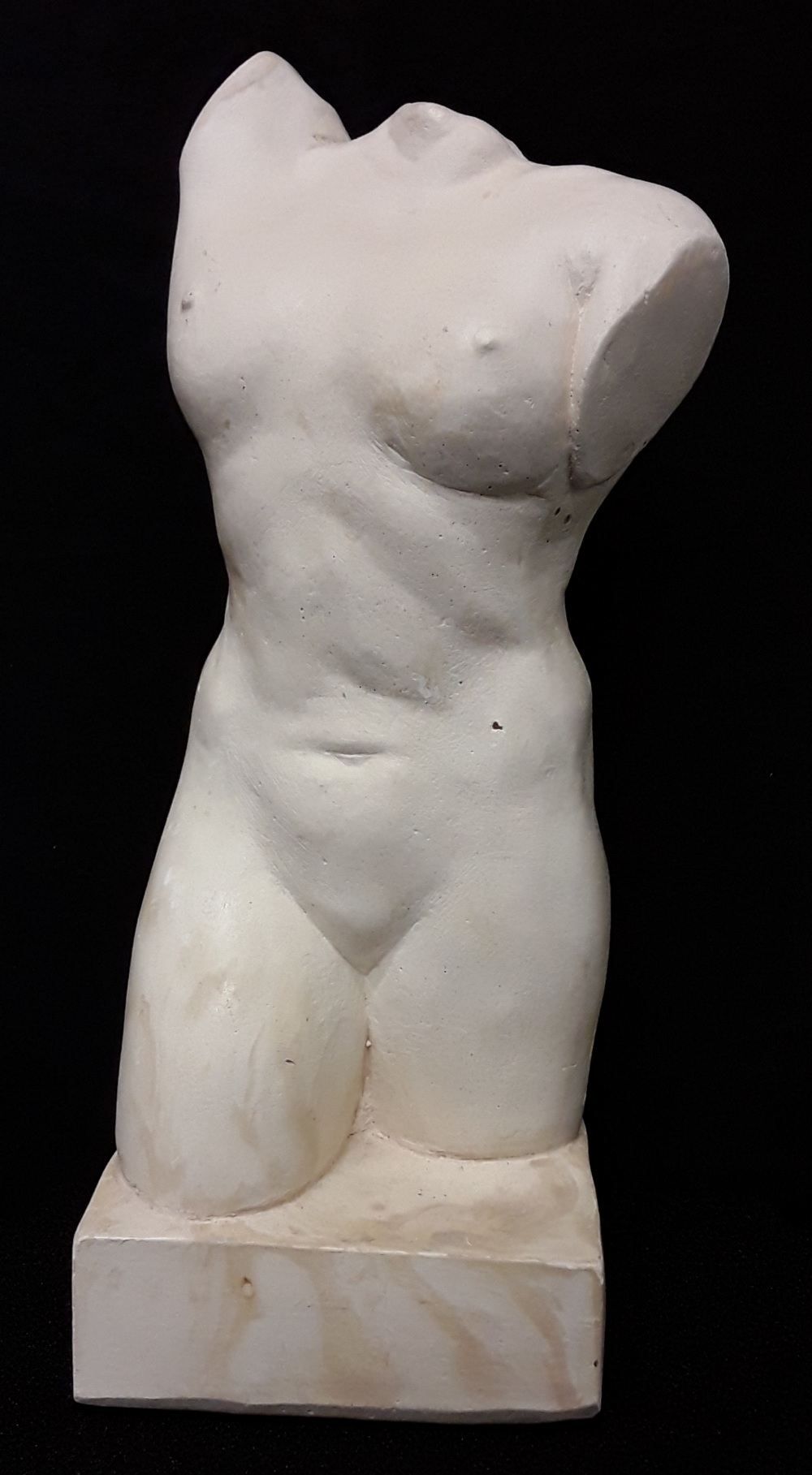 A ceramic sculpture of a female torso.