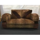 An Art Deco Cloud sofa and armchair with leopard print upholstery.