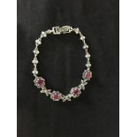 A silver marcasite and ruby panelled line bracelet.