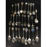 A large collection of commemorative silver plated collector's spoons.