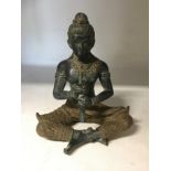 A bronze figure of an Indian deity.