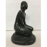 An Art Deco bronze sculpture by A. Gennarelli depicting a kneeling woman.