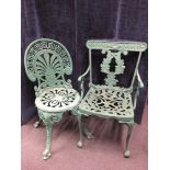 Two Victorian wrought iron garden chairs in green.