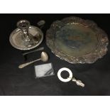 An assortment of silver plate including a card case, teething ring, candle holder etc.