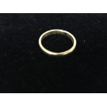 A 22 ct yellow gold wedding band.