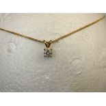 A 9ct yellow gold chain and pendant. The pendant set with a solitaire diamond.