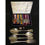 A WW1 medal set two enamel badges and four military spoons.