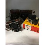 A collection of vintage cameras together with a pair of cased field binoculars.