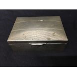 A silver plated cigarette box with wood liner. Miscellaneous contents included.