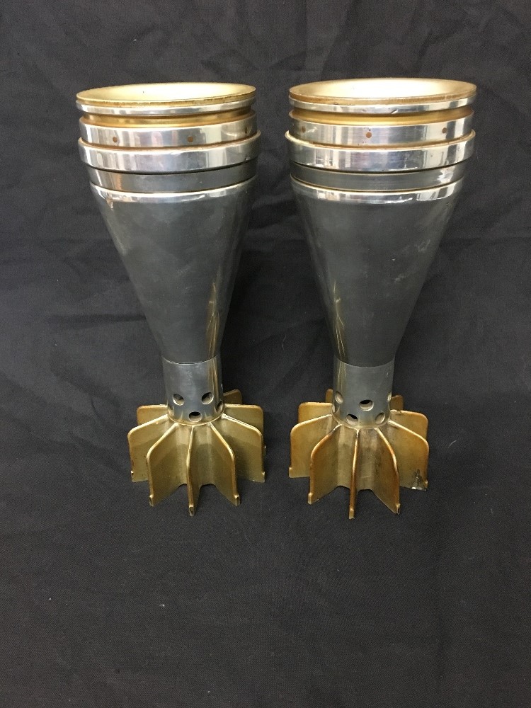 A pair of polished mortar shells.