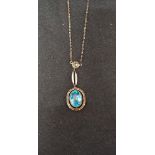 A 9ct gold chain and pendant set with a large blue topaz.