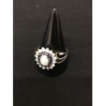 A silver dress ring set with opals and amethysts.