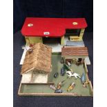 A pair of wooden toy play sets: petrol station and a farm with a selection of Britains lead figures.