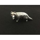 A silver figure of a fox set with ruby eyes. Hallmarked Sterling.