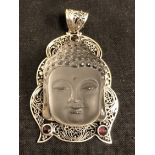 A silver and rock crystal necklace pendant in the form of Buddha.