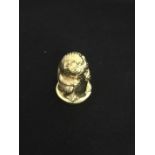 A gold plated silver thimble in the form of a rabbit.