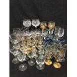 A large collection of drinking glasses of various styles and makes