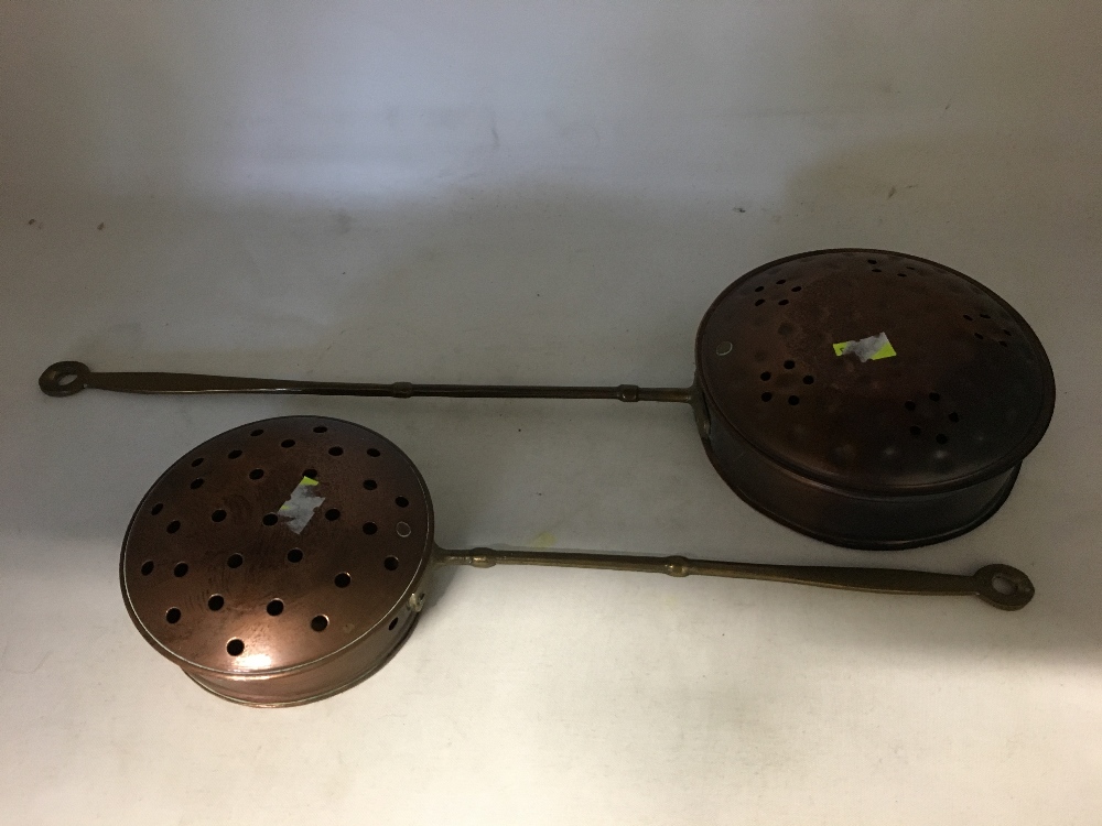 Two miniature copper bed warmers. Being sold on behalf of The Salvation Army.