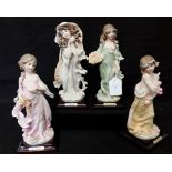 Four figurines marked G. Armani. Height 20cm.