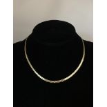 A 9ct gold necklace in herringbone links.