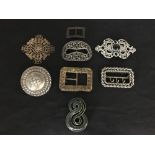 An assortment of eight belt and shoe buckles including one of filigree wirework.