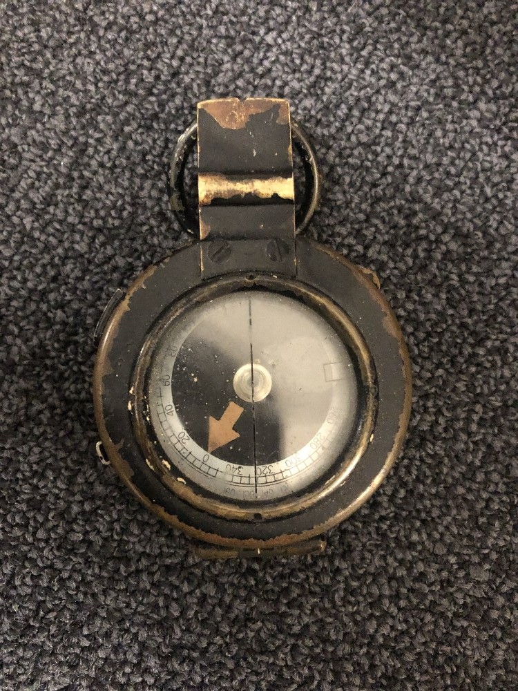 A 1938 dated Pattern Mk.IX compass marked J.M. Glauser in leather case.