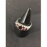 A silver ring set with garnets. Hallmarked Birmingham.