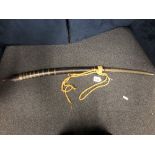 A 19th century Burmese Dha sword in its wood and brass scabbard. Blade length 48cms