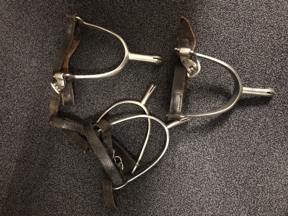 Two pairs of 20th century cavalry spurs with straps.