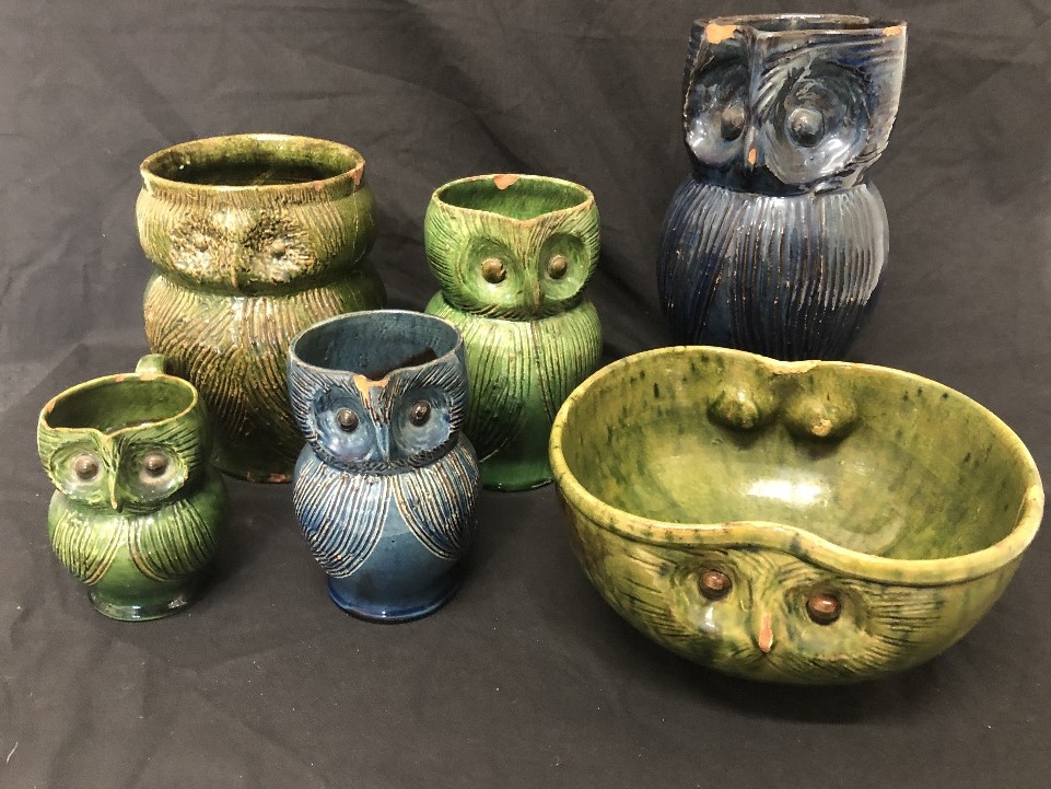 A collection of owl jugs and an owl bowl by Farnham Pottery.