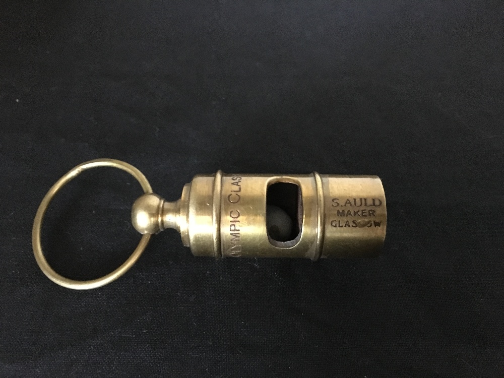 A brass White Star Line whistle.