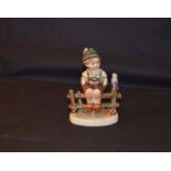 A Hummel Figurine 'Boy on Fence'