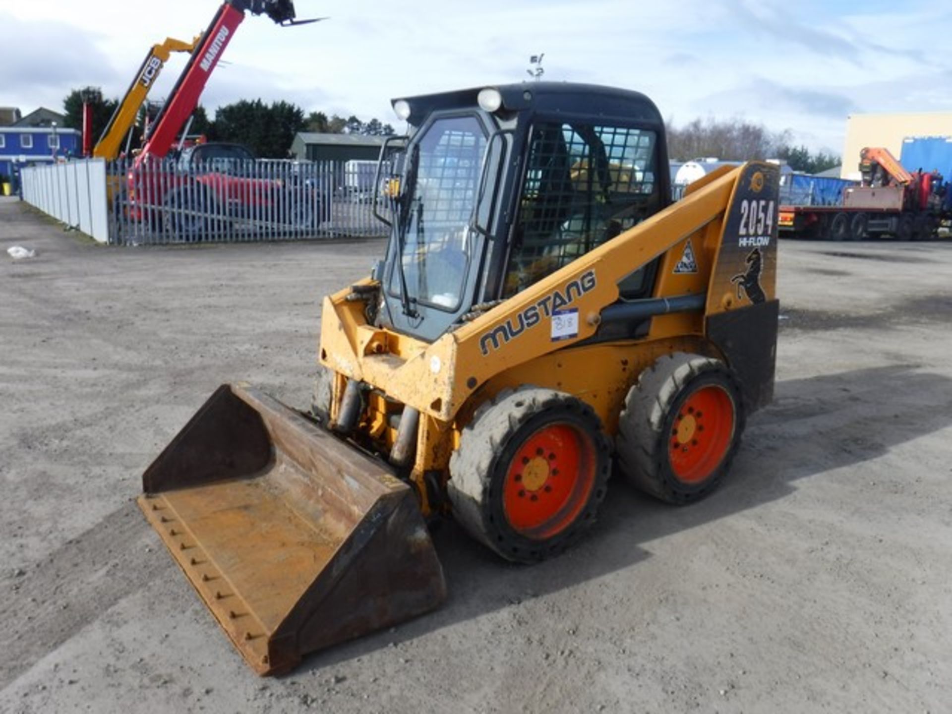 2014 Mustang 2054 skid steer loader c/w door kit, solid wheels, hi-flo hydraulics, rear co