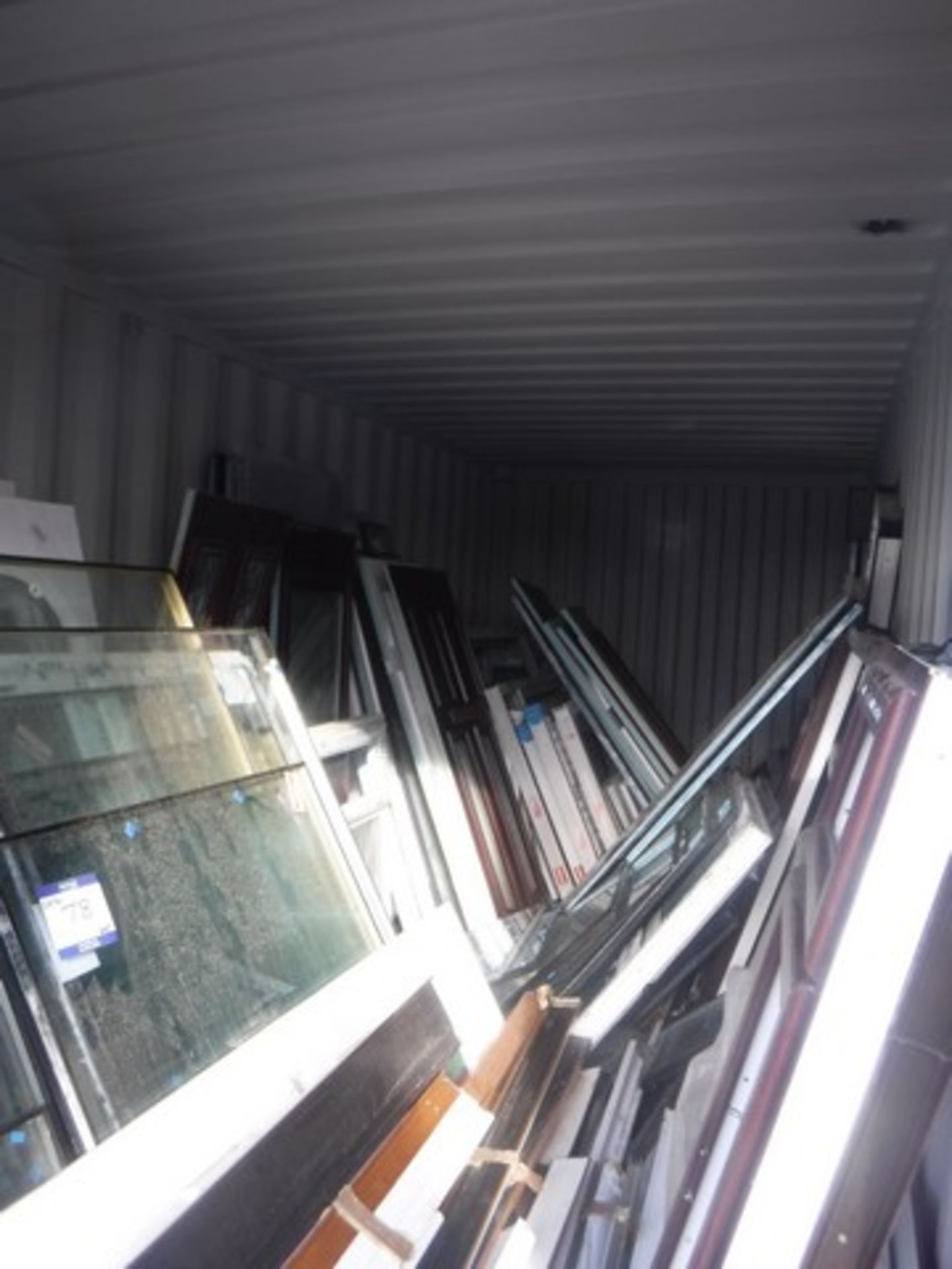 Clearance lot of PVC windows, door panels, cills and assorted glass. Container NOT includ