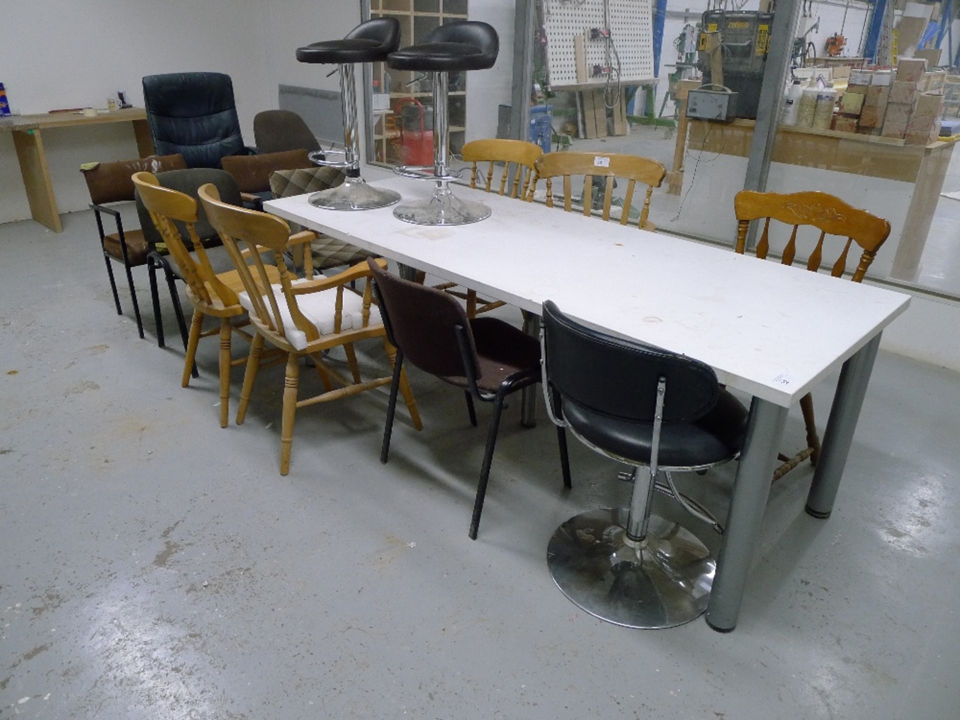 1 white rectangular table and 15 various chairs / stools – located in rest room