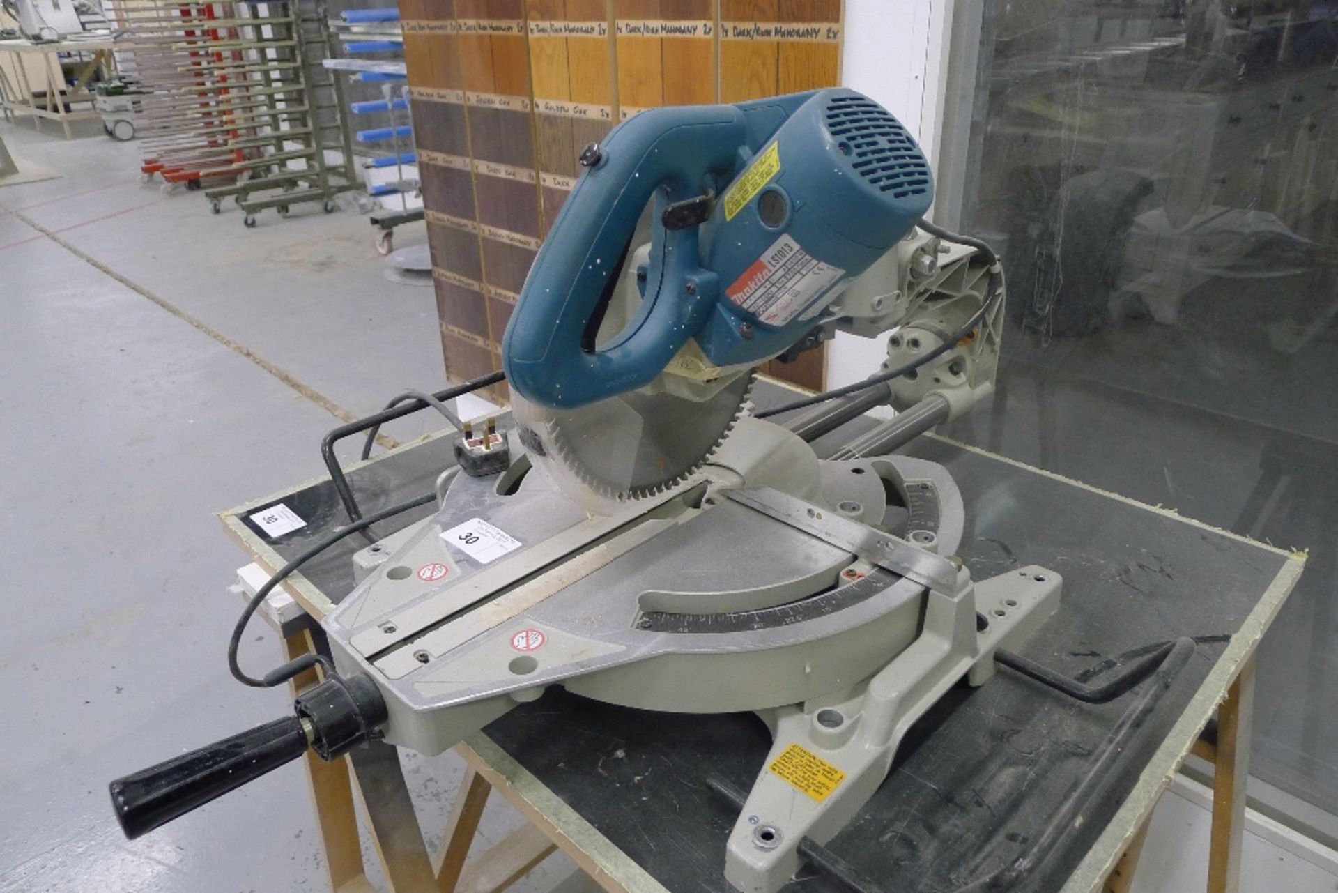 1 sliding mitre saw by Makita type LS1013, 240v with two wooden trestle type stands and a board - Image 2 of 4