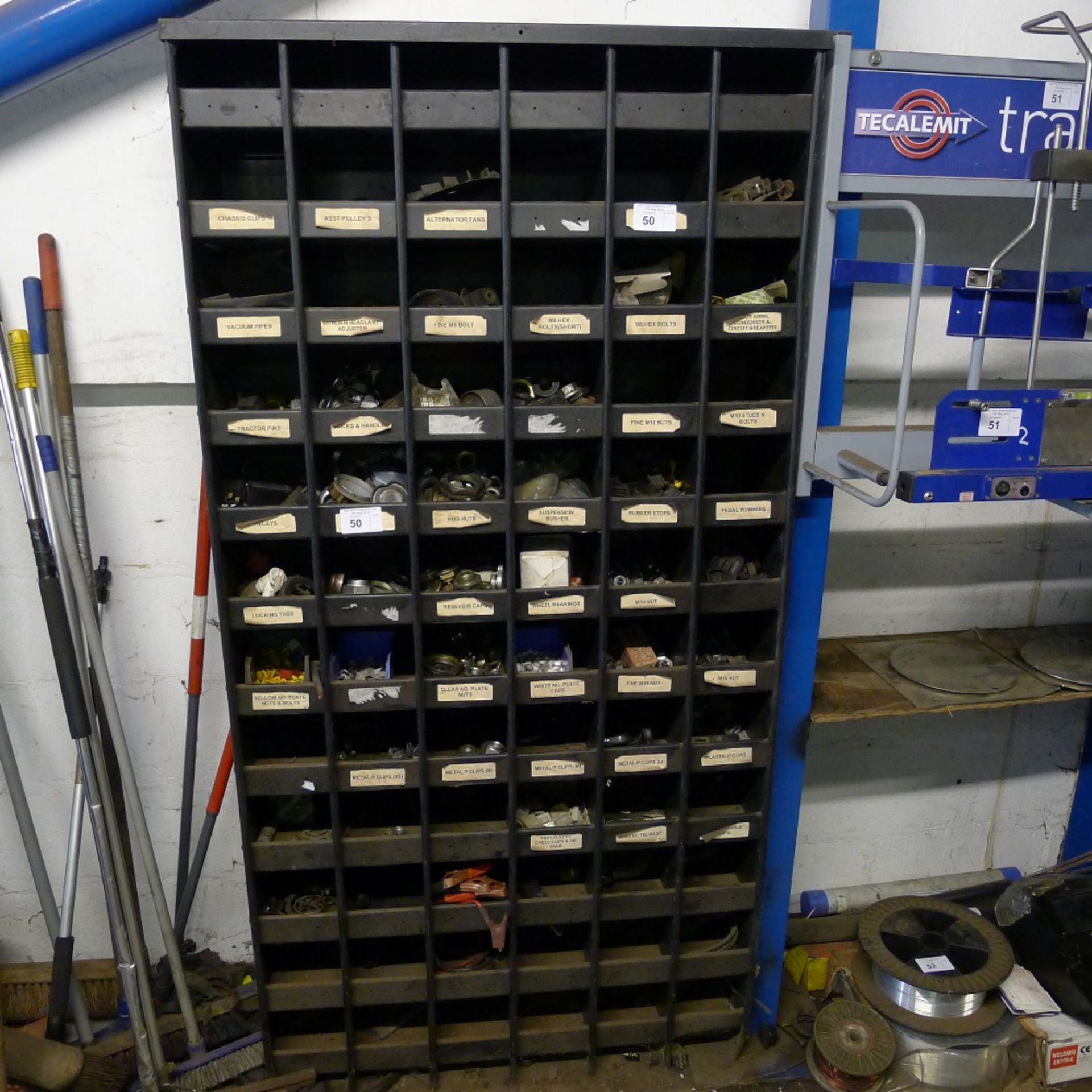 1 metal parts storage rack containing various auto related items. Not practical to list in detail,