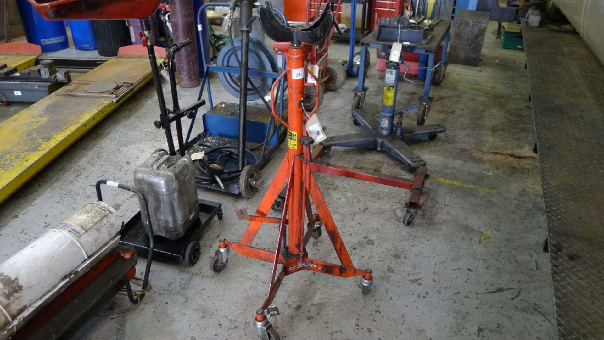 1 orange painted high lift transmission jack