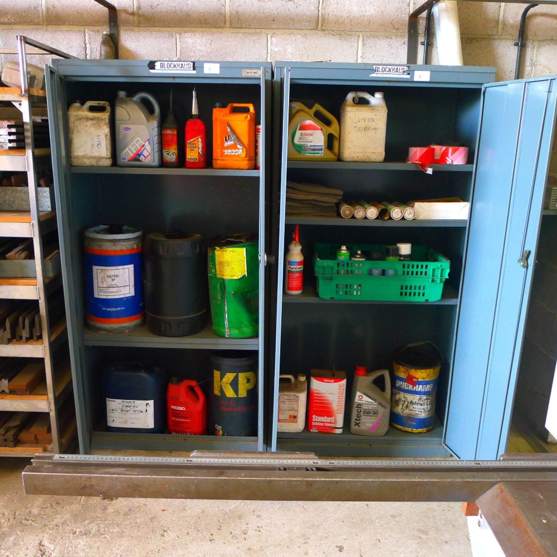 2 grey metal storage cabinets each approx 6ft x 3ft containing various part used drums of oil,