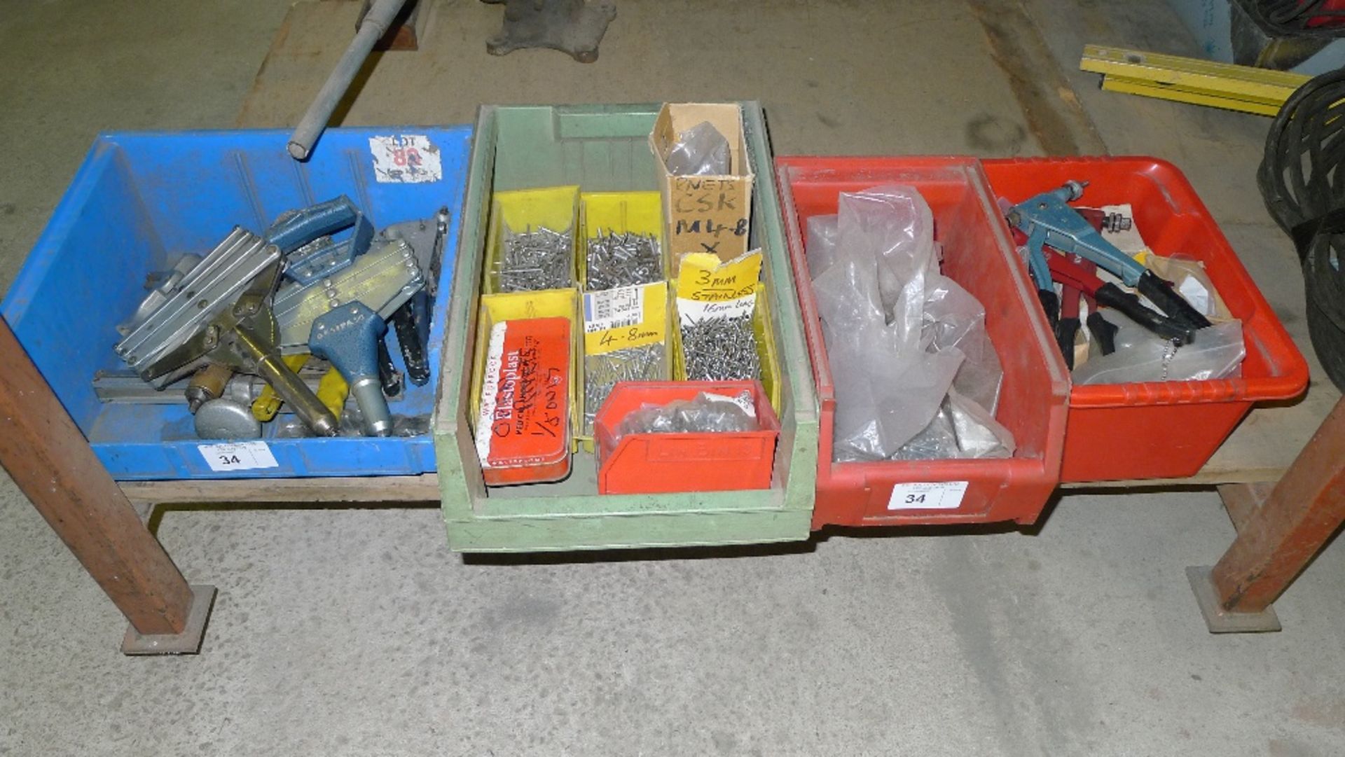 a quantity of various rivet guns, rivets, pop guns and pop nuts