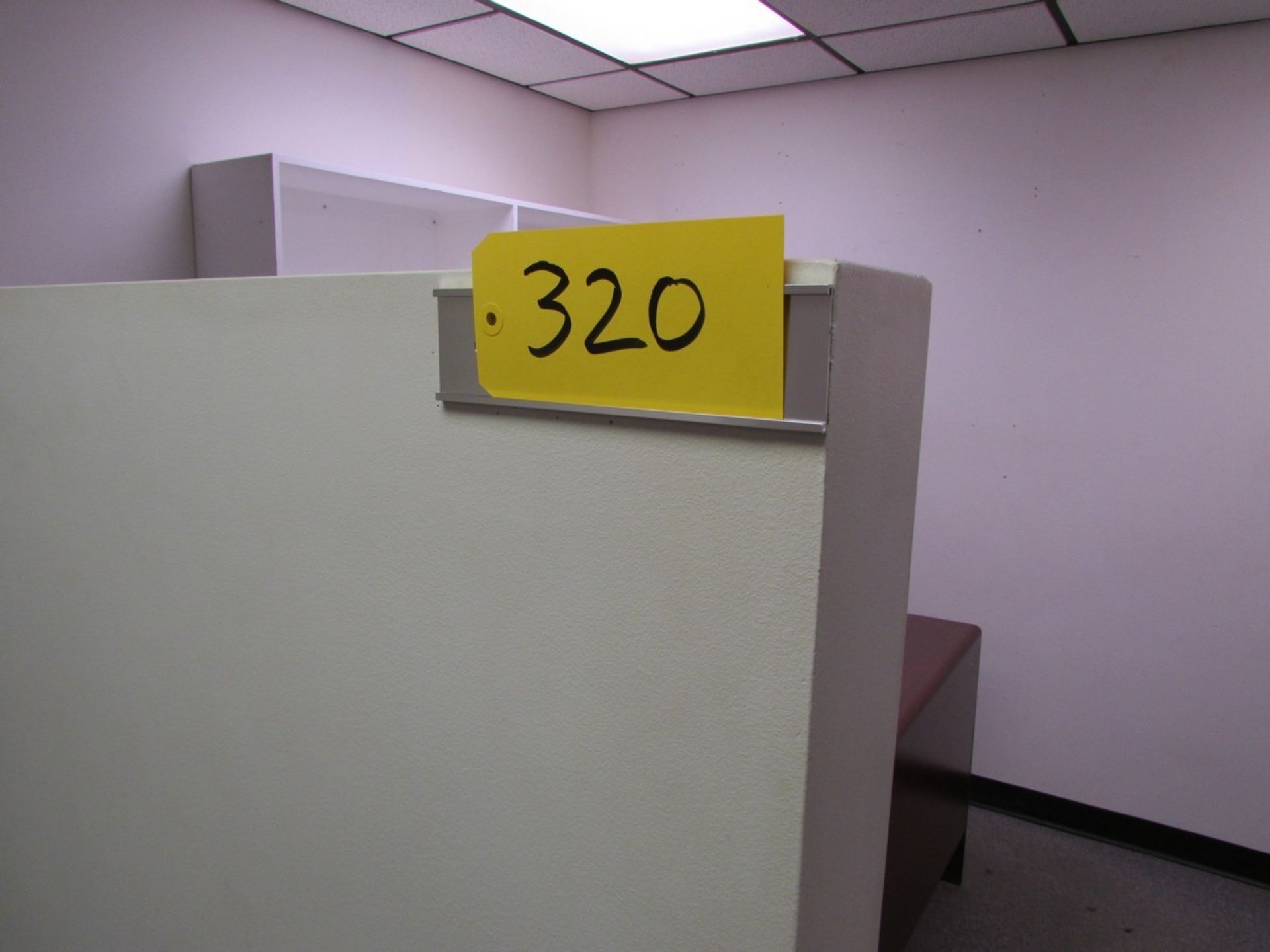 Contents of cubicle includes Dell 24" computer monitor and paper shredder, L shaped desk.