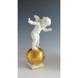 Putto auf großer Kugel. Weiß und golden staffierte Figurine. Bez. K(arl) Tutter. Lorenz
