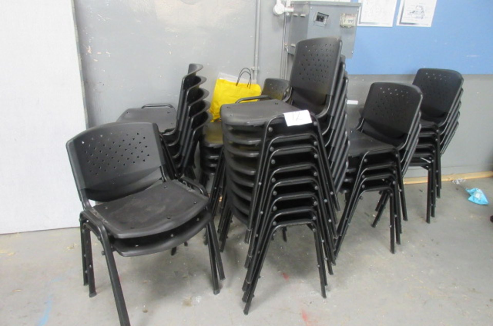 Twenty eight black stackable matching chairs