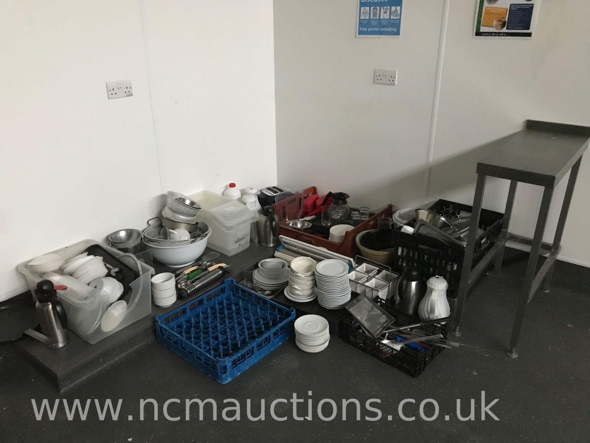 Various kitchen utensils and stainless steel prep table