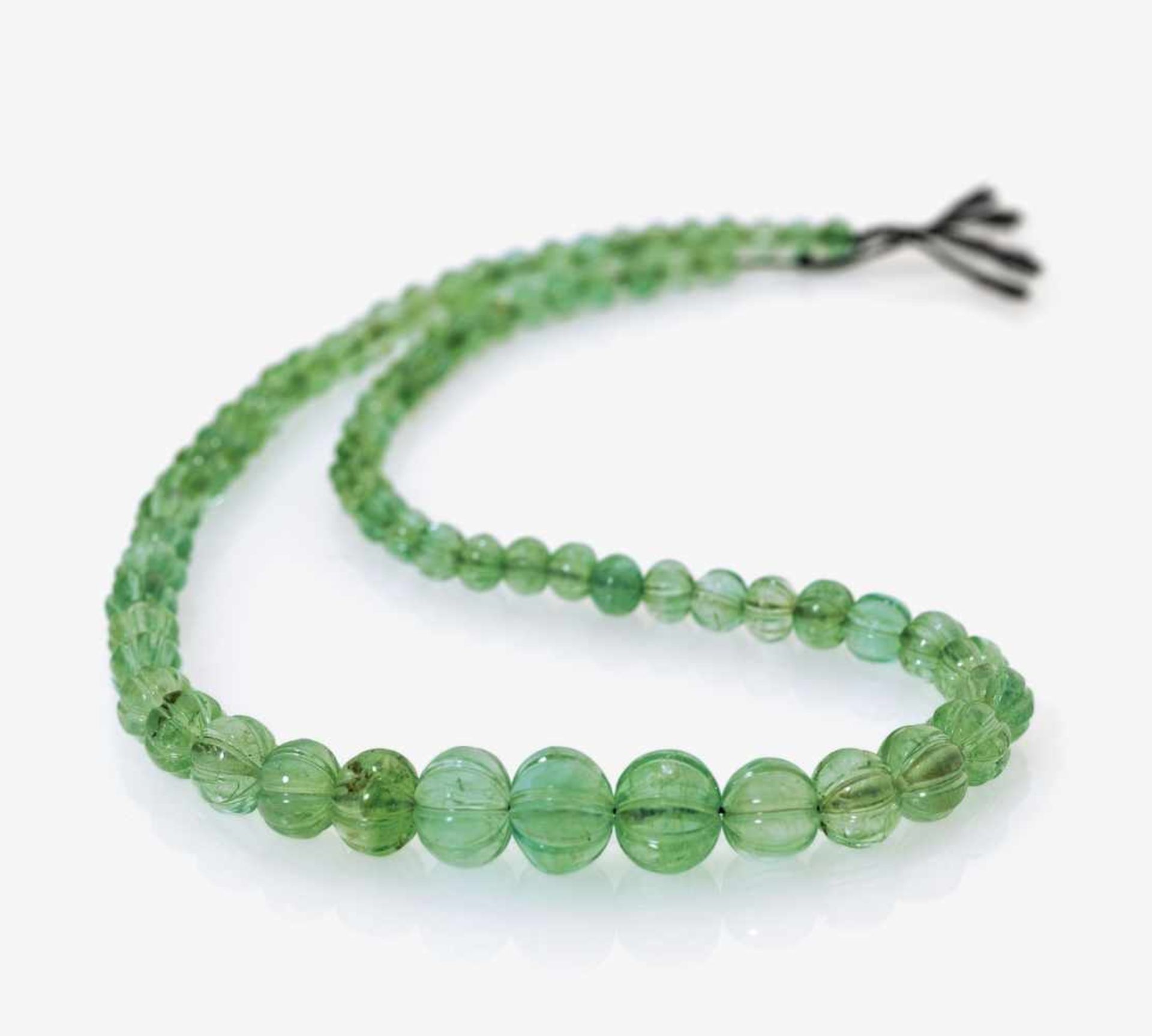 An Emerald Necklace73 faceted emerald beads, diameter circa 5.5 - 13.1 mm. Length circa 44.5.
