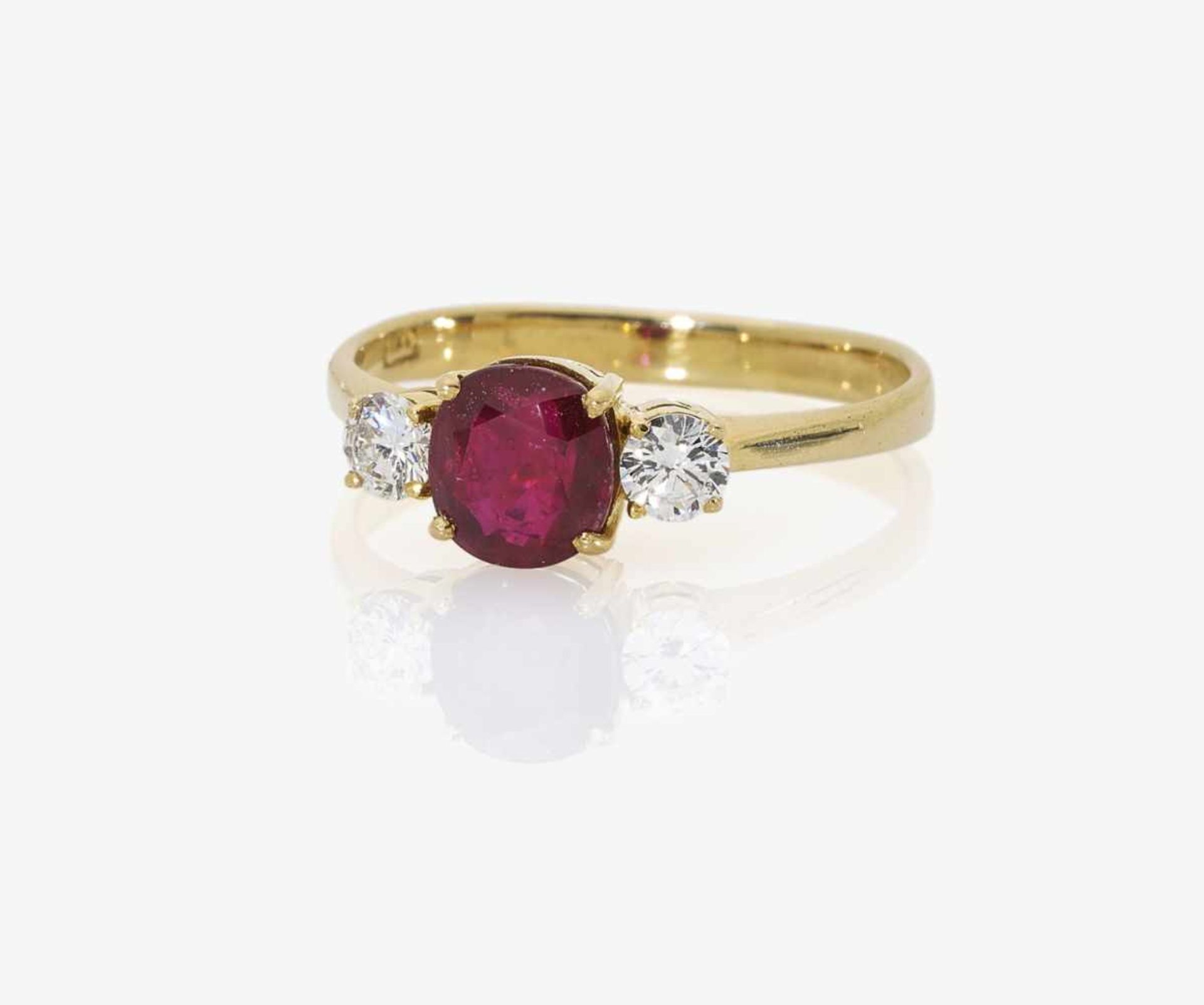 A Three-Stone Ruby and Diamond RingGermany 18K yellow gold (750/-), stamped. Maker's mark. 2